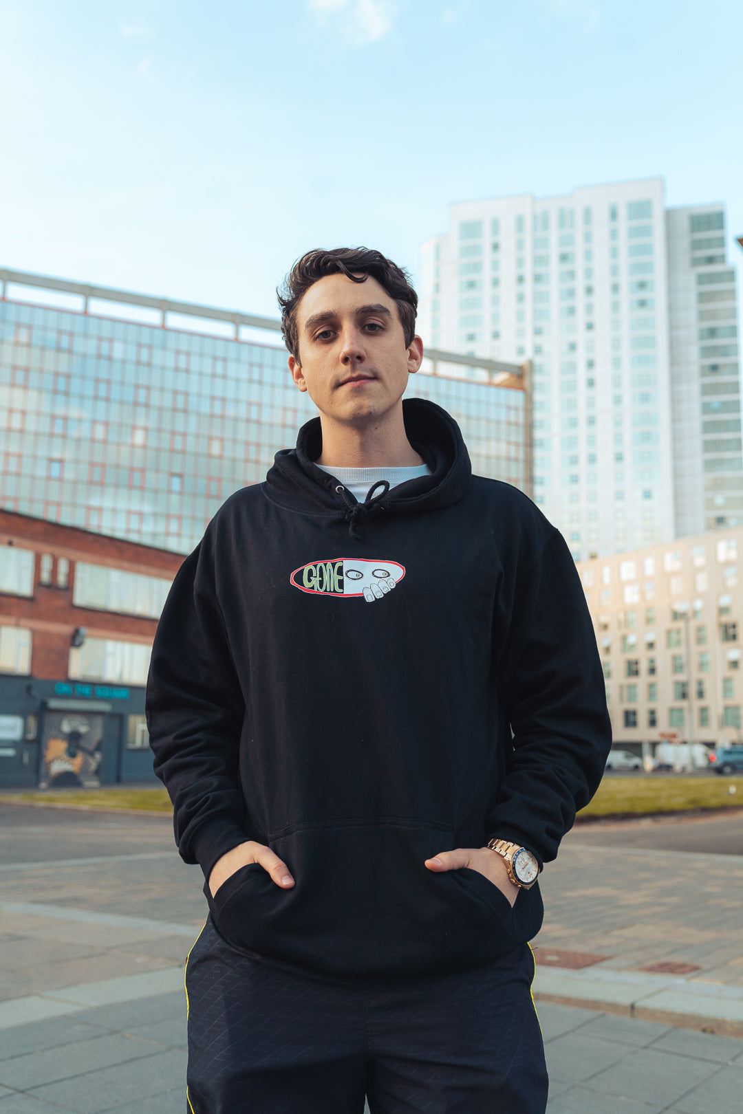 man wearing black graphic hooded sweatshirt
